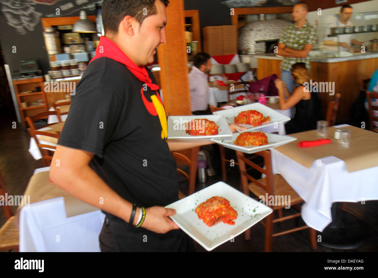 Restaurant waiter carrying plates hires stock photography and images