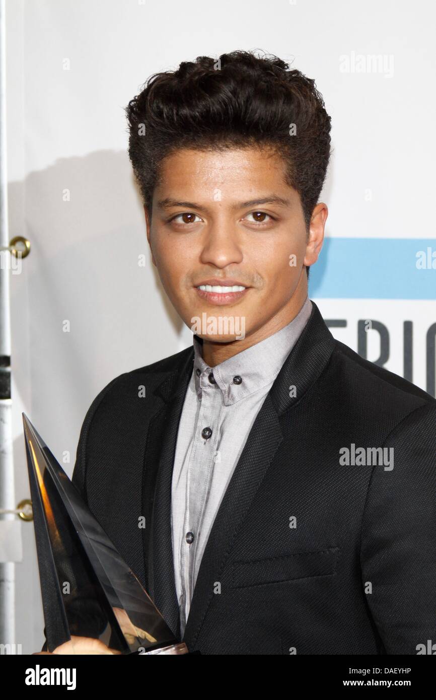 American R&B singer Bruno Mars poses in the press room of the 2011