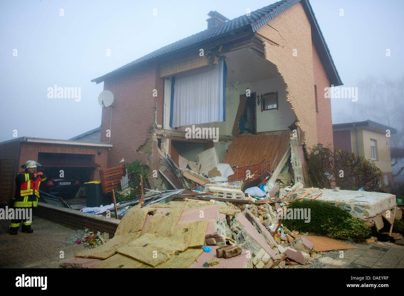 A Fireman Stands In Front Of A Collapsed House In Bergheim