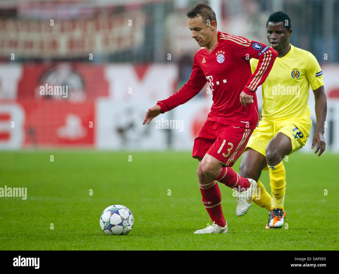 Munichs's Rafinha (L) and Villarreal's Wakaso Mubarak vie for the ball during the Champions League group A soccer match between FC Bayern Munich and Villarreal CF at the Allianz-Arena in Munich, Germany 22 November 2011. Photo: Sven Hoppe dpa Stock Photo
