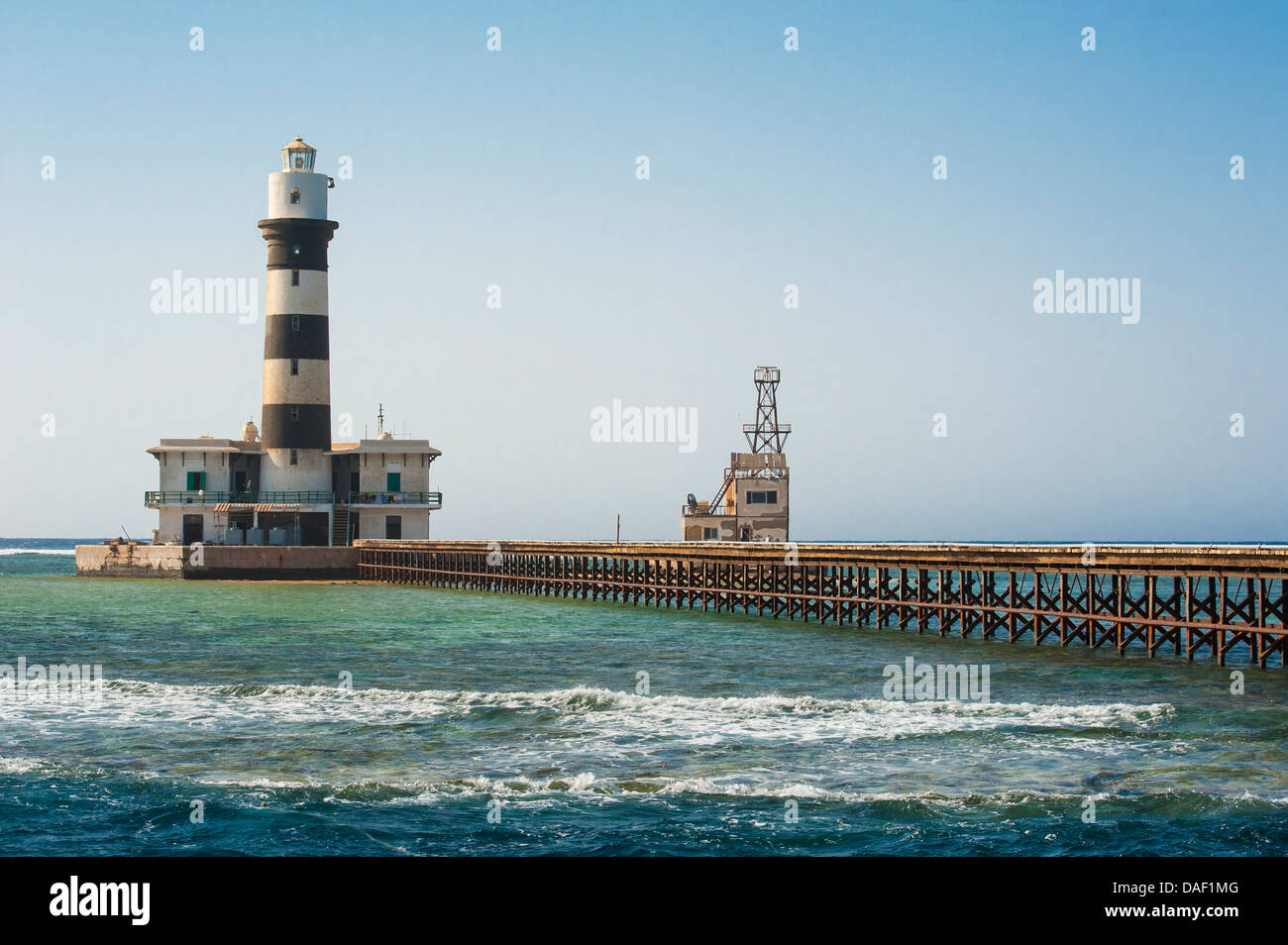 Old lighthouse building on an offshore tropical reef in the Red Sea Stock Photo