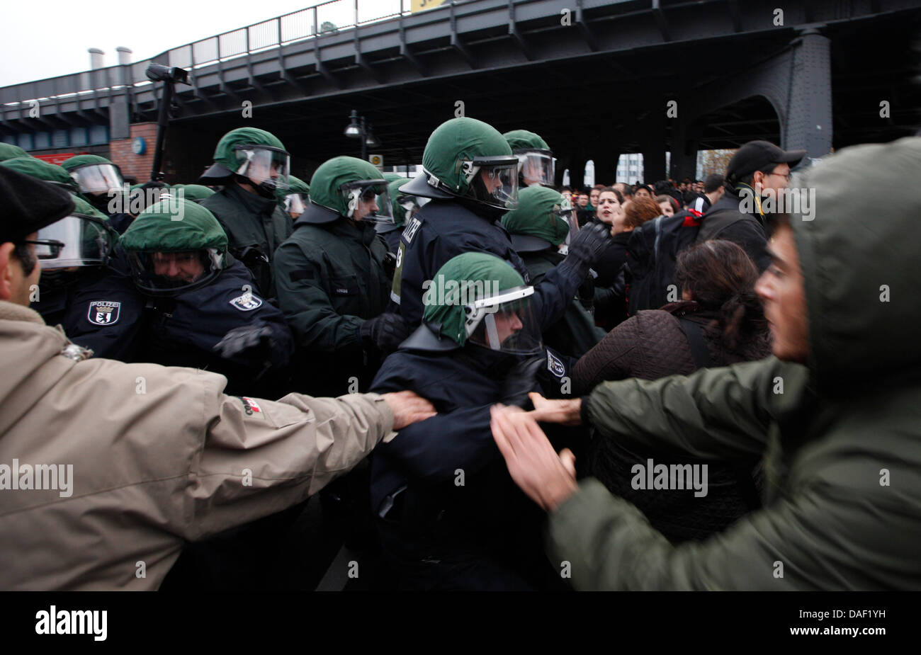 Demonstrators clash with police officers during a demonstration against fascism and police state in Berlin, Germany, 26 November 2011. Several hundred people demonstrated in the streets and criticised the yet unclear relationship between constitution protection and members of the National Socialist Underground (NSU). After a Kurdish demonstration was stopped on the same day, severa Stock Photo