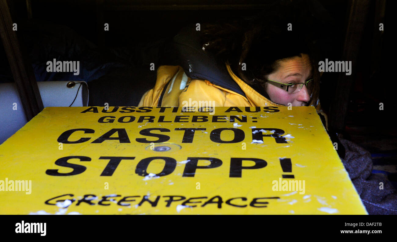 Anti-nuclear activists from the environmental group Greenpeace have moored to the street with their van during a protest action against the castor transport in  Klein Gusborn, Germany, 28 November 2011. The Greenpeace activists aim to block the southern castor transport route. The 13th Castor transport with German nuclear waste is expected in Wendland from the reprocessing plant in Stock Photo