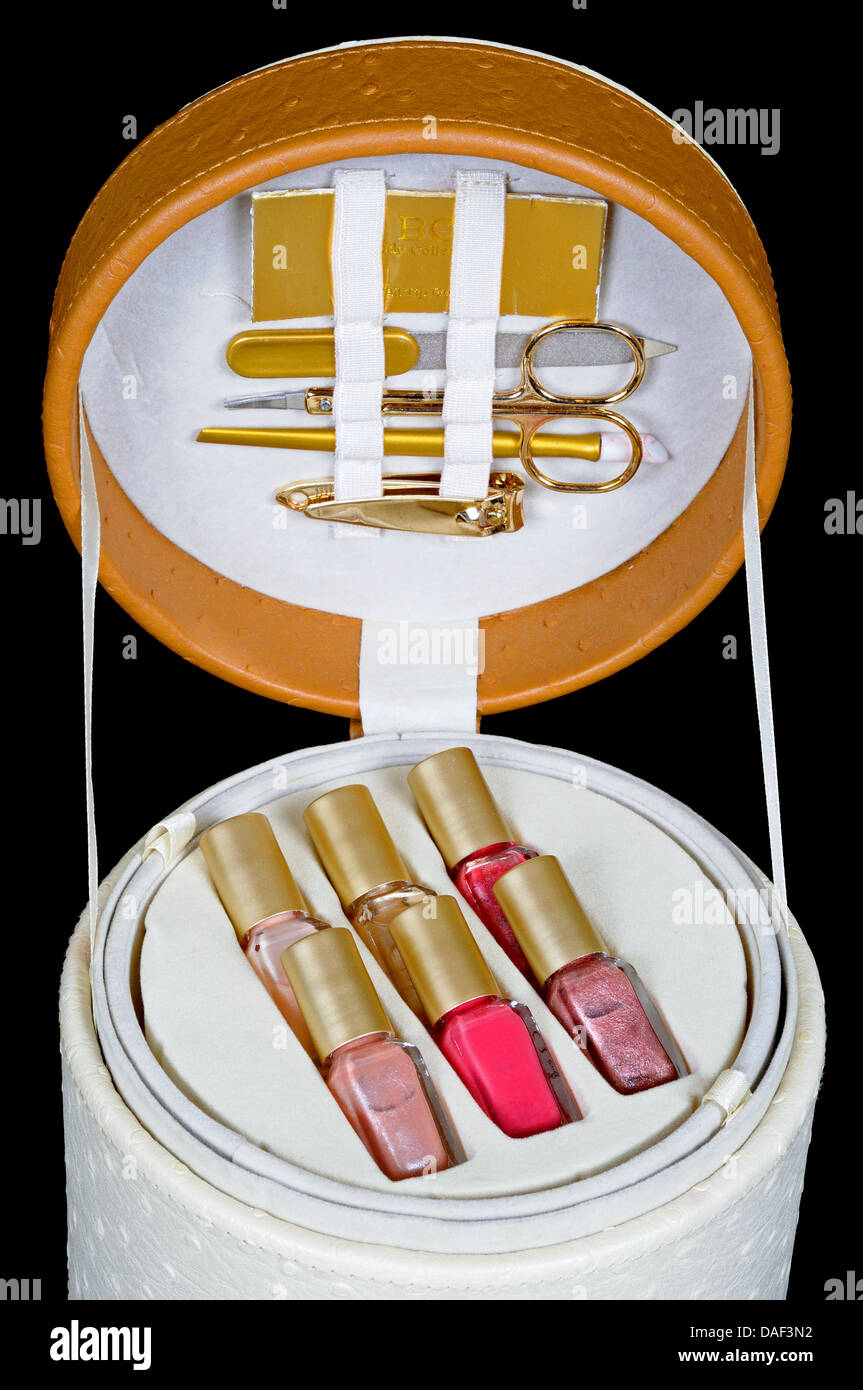 Manicure set and nail varnish in a round case against a black background. Stock Photo