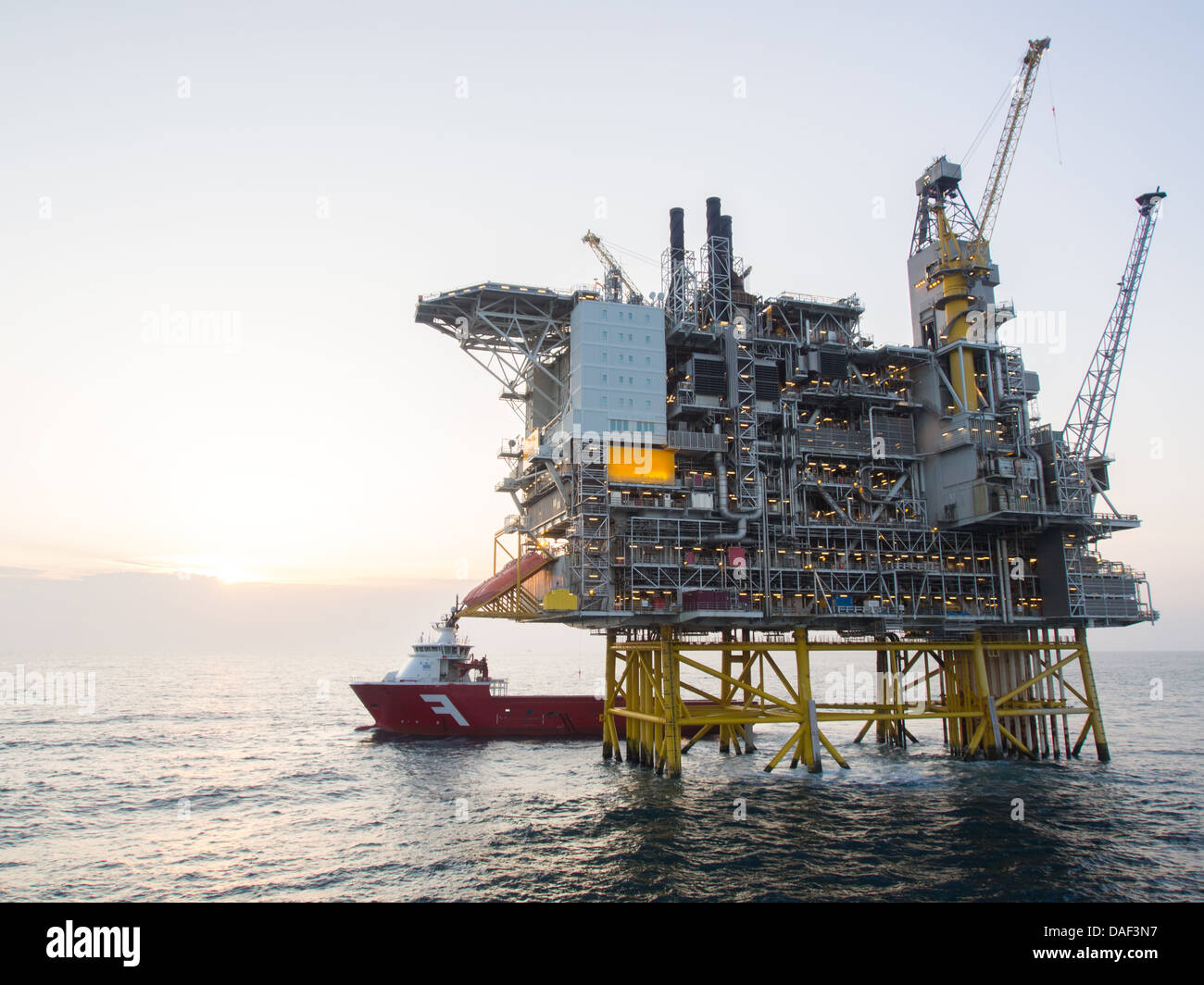 Offshore oil platform with a supply vessel on the North Sea, in the Norwegian sector Stock Photo