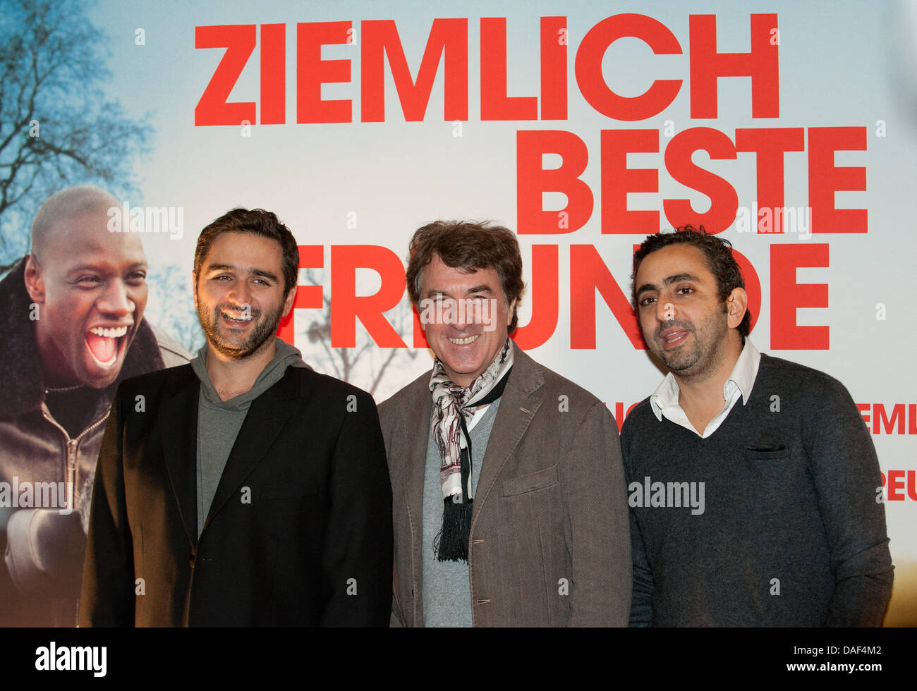 Actor Francois Cluzet (C) and directors Olivier Nakache (R) and Eric Toledano arrive for the opening film 'Intouchables' of the 11th French Film Week at the International movie theatre in Berlin, Germany, 01 December 2011. Photo: Joerg Carstensen Stock Photo