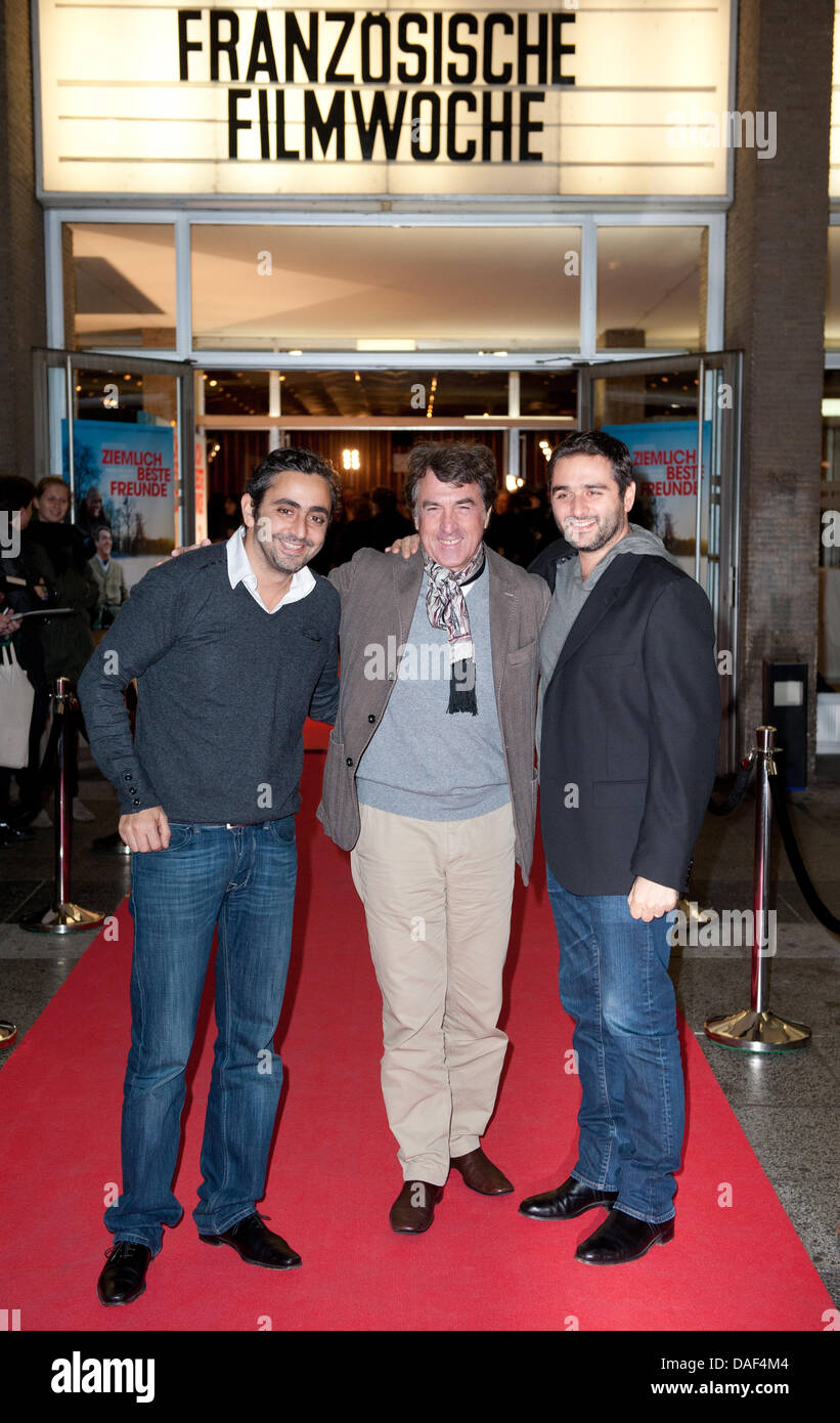 Actor Francois Cluzet (C) and directors Olivier Nakache (L) and Eric Toledano arrive for the opening film 'Intouchables' of the 11th French Film Week at the International movie theatre in Berlin, Germany, 01 December 2011. Photo: Joerg Carstensen Stock Photo