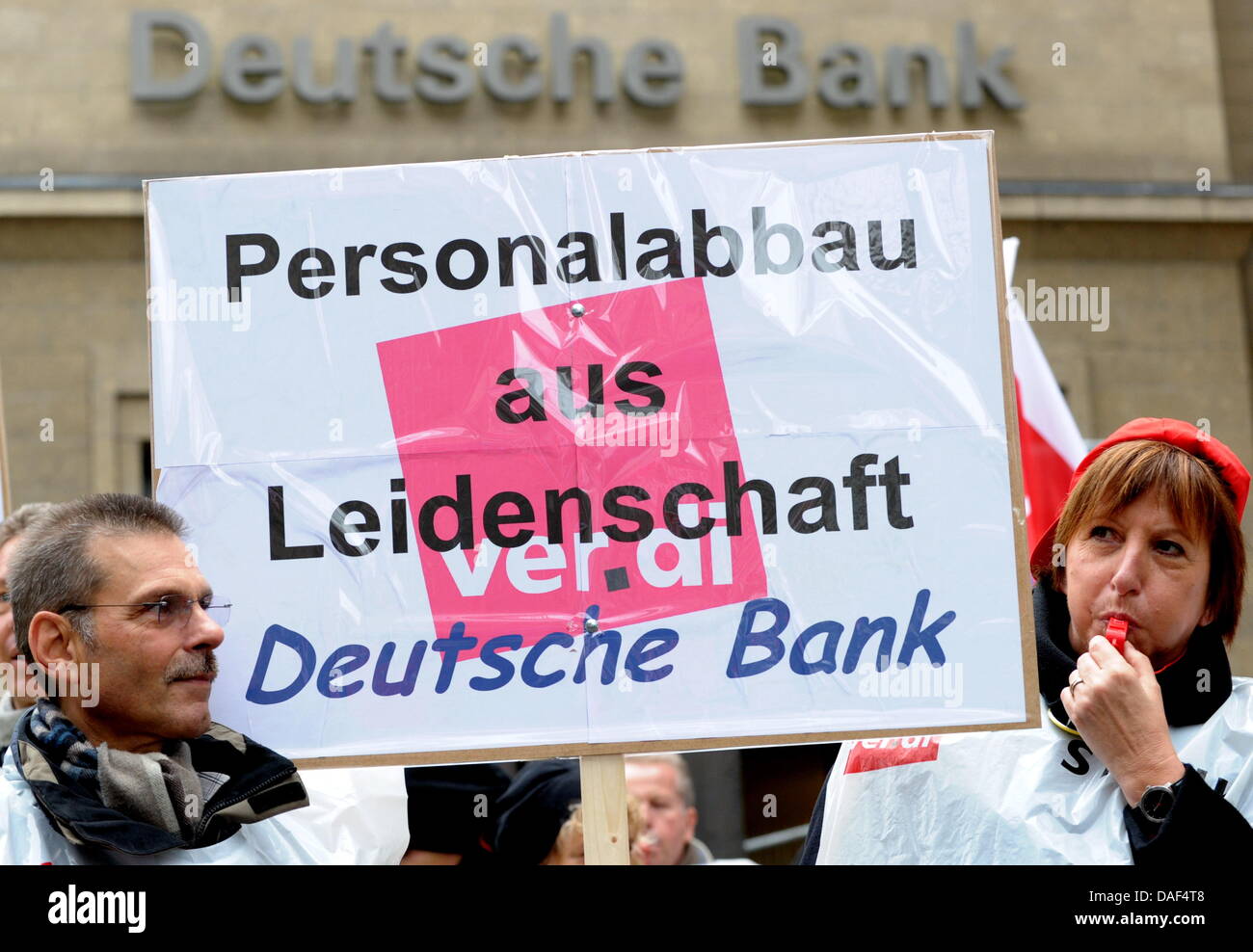 Postbank employees protest in front of a Deutsche Bank branch in Cologne, Germany, 02 December 2011. The union Verdi has called for nation-wide warning strikes. The employees protest against the plans of Postbank owner Deutsche Bank to decrease salaries and increase working hours. Photo: Federico Gambarini Stock Photo