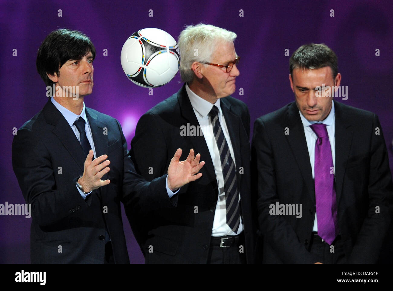Coach Joachim Loew of Germany (l, with coach Morton Olson of Denmark (C) and coach Paulo Bento of Portugal) plays with the new official EURO ball during the final draw for the UEFA EURO 2012 soccer championships at the Palace of Arts in Kiev, Ukraine, 02 December 2012. The European soccer championships will take place from 08 June to 01 July 2012 in Poland and Ukraine. Photo: Thoma Stock Photo