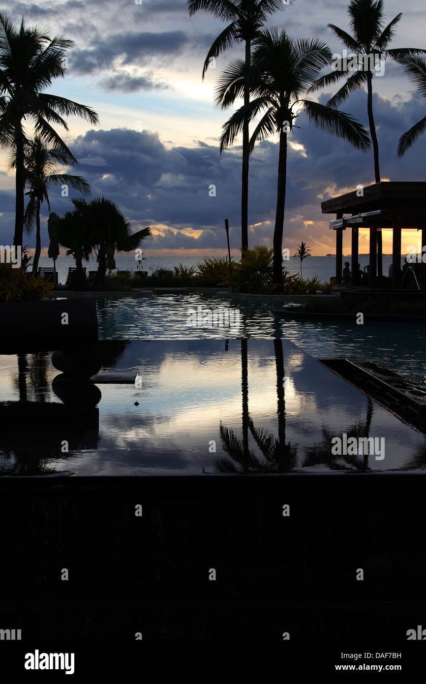 Beautiful tropical resort pool at sunset, Denarau Island, Fiji Stock Photo