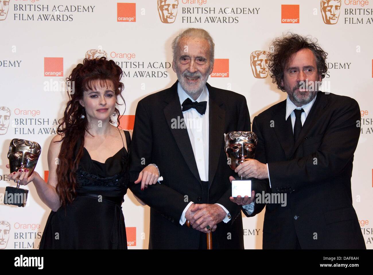 Christopher Lee (C) poses with director Tim Burton and Helena Bonham Carter  poses in the winner's pressroom of the Orange British Academy Film Awards,  aka Baftas, at Royal Opera House in London,
