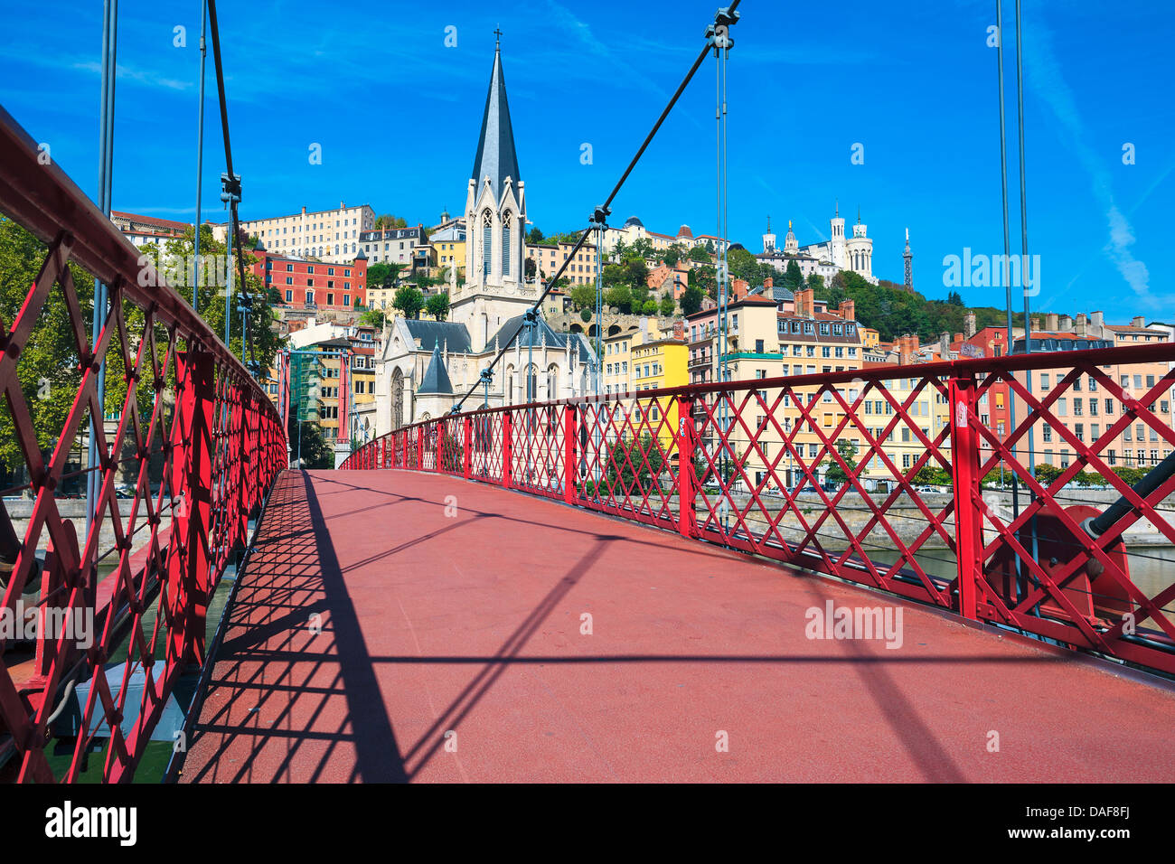 View of Lyon city with red footbridge on Saone river and church Stock Photo