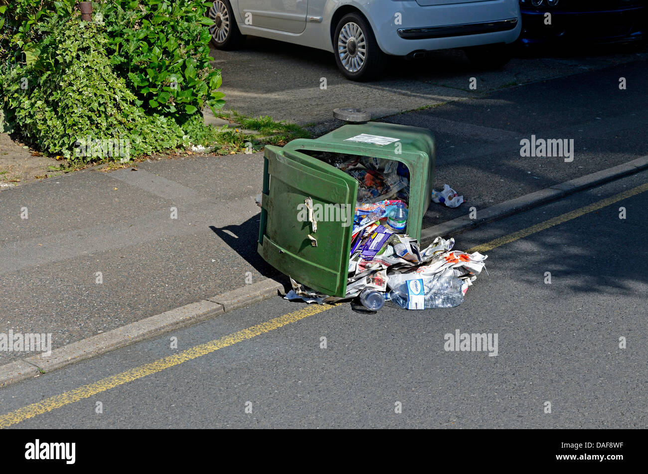 Maidstone, Kent, England. Household rubbish bin fallen over in the street Stock Photo