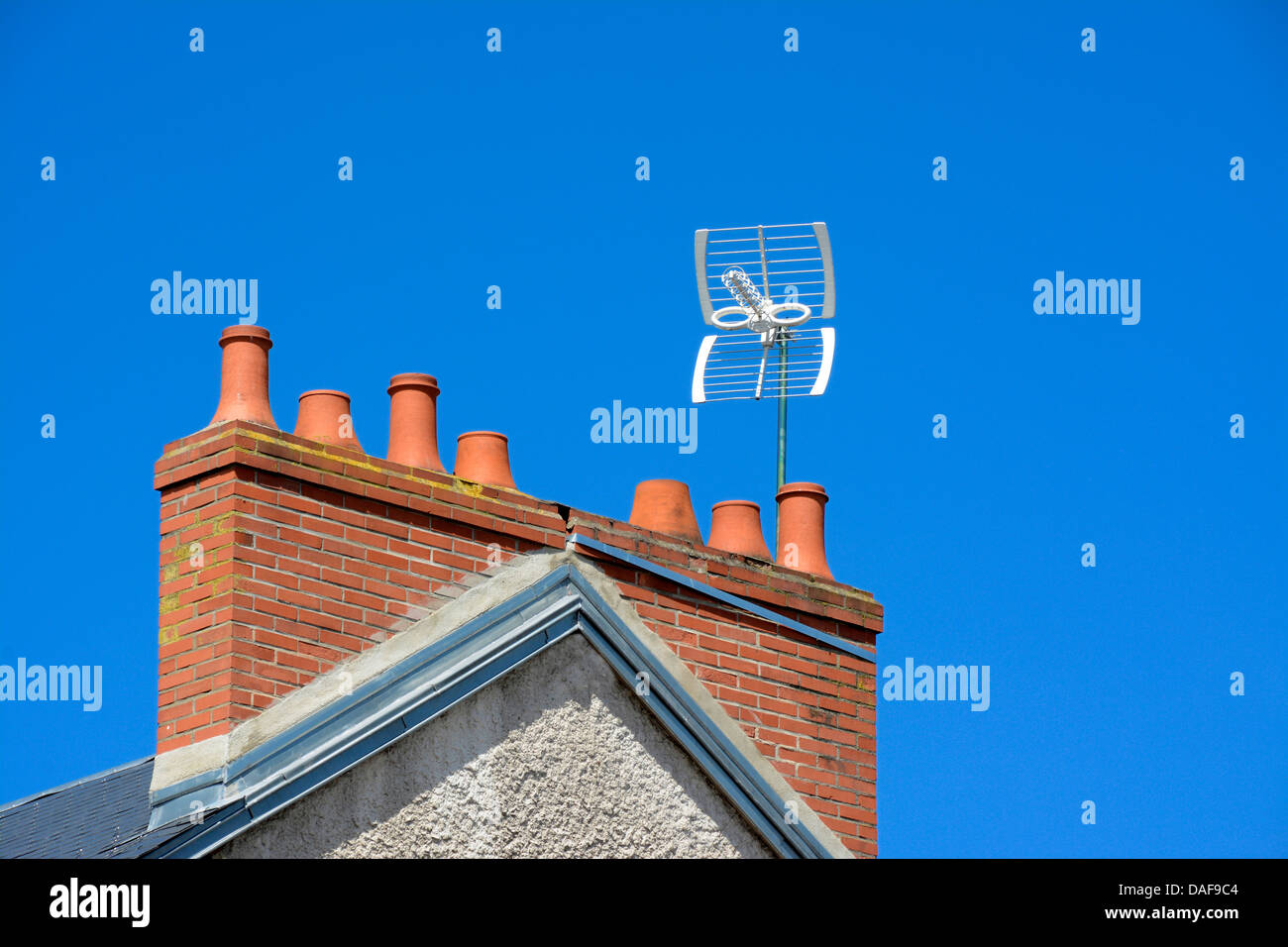 Close-up of brick chimney with TV antenna. France. Stock Photo