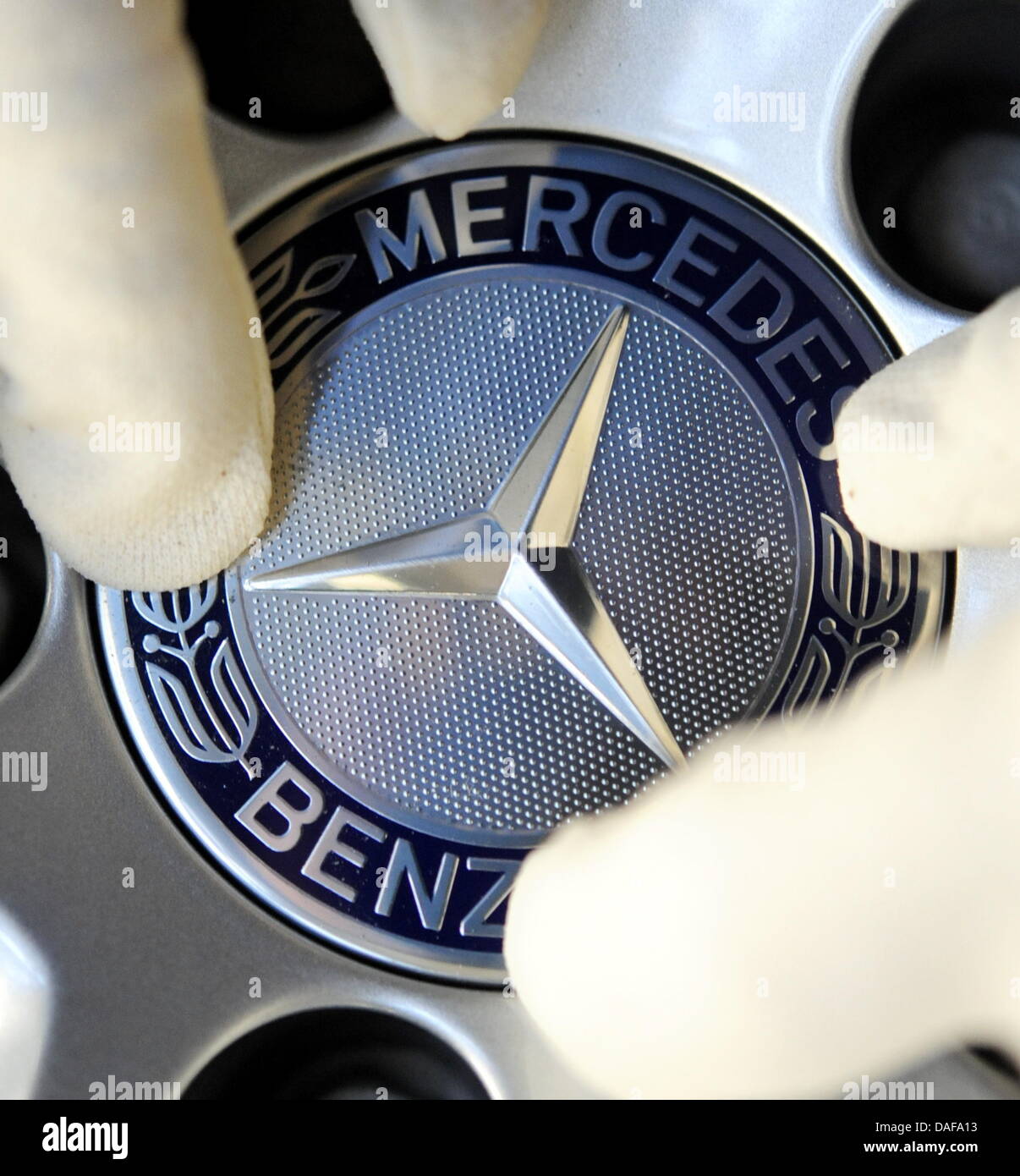 A file picture shows the logo of Mercedes-Benz during assemblage at a plant in Sindelfingen, Germany, 1 February 2011. The Stuttgart-based car company wants to present a positive annual balance at their press conference on 16 Feruary. Daimler wants to beat their production record of 2007. Photo: Bernd Weissbrod Stock Photo