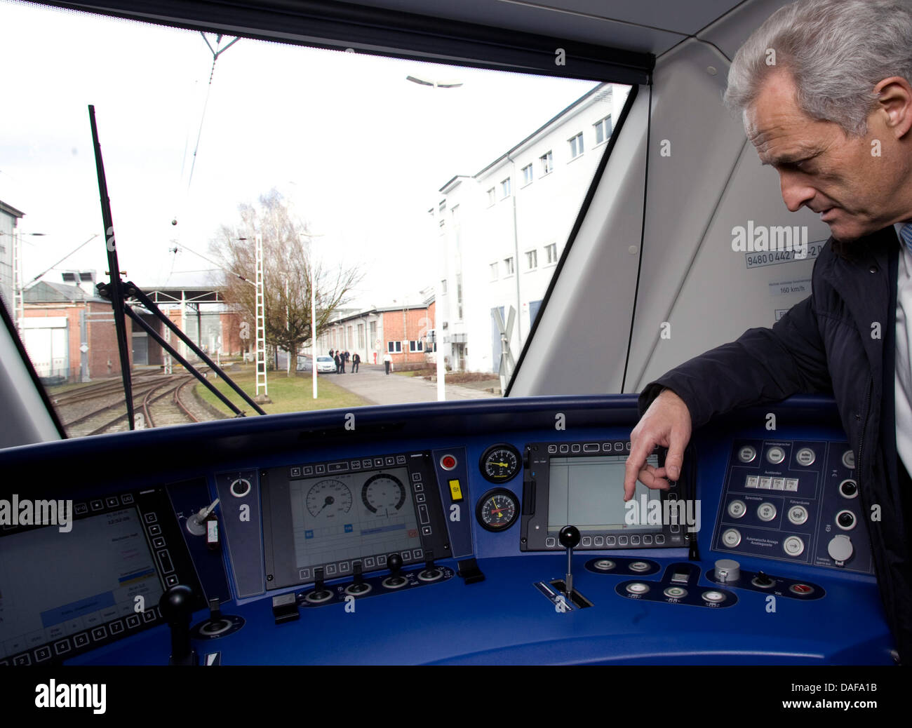 German Minister of Transport Peter Ramsauer looks at the cockpit of a train during a visit to a plant of the Canadian rail car producing company Bombardier in Henningsdorf, Germany, 11 February 2011. Ramsauer got an update on trains such as 'Talent 2'. Photo: Martin Foerster Stock Photo
