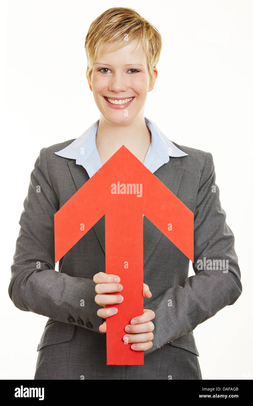 Happy young business woman with arrow pointing towards her Stock Photo ...