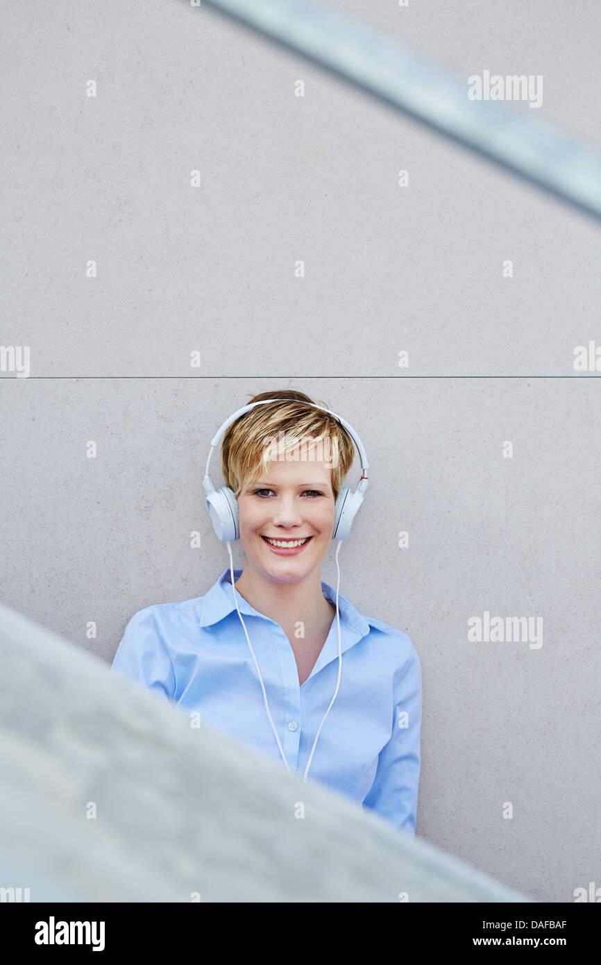 Happy young woman with headphones listening to music Stock Photo