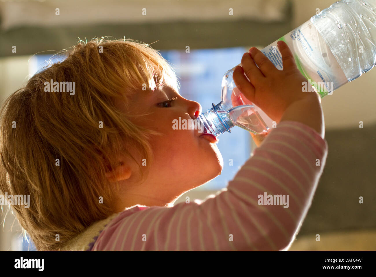 Girl drinking water from bottle, close up Stock Photo