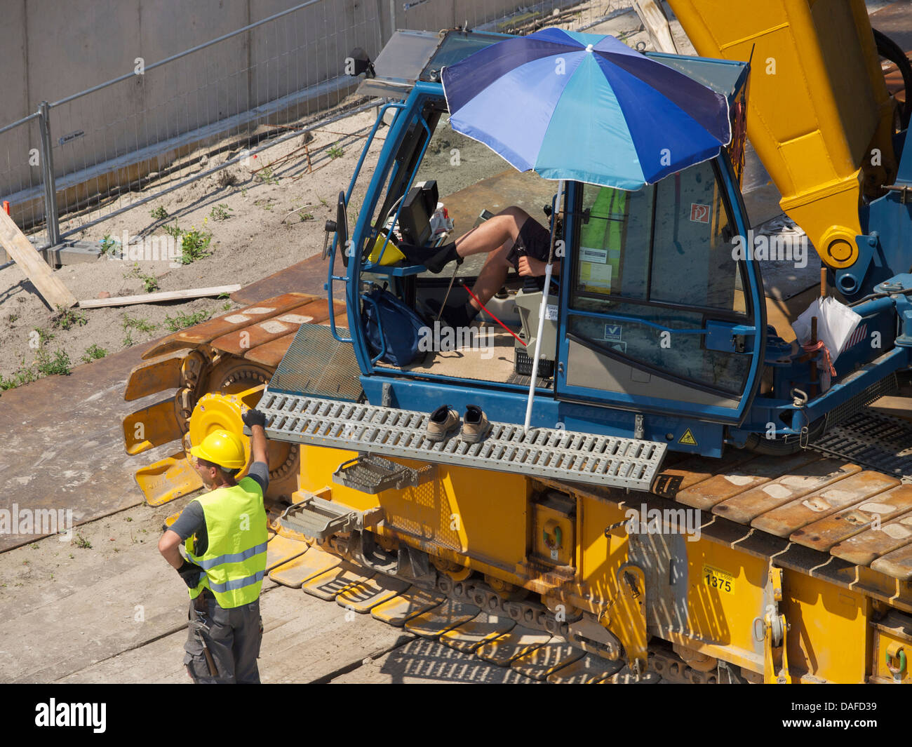 Crane driver and his colleague with a relaxed attitude towards work. Breda, the Netherlands Stock Photo