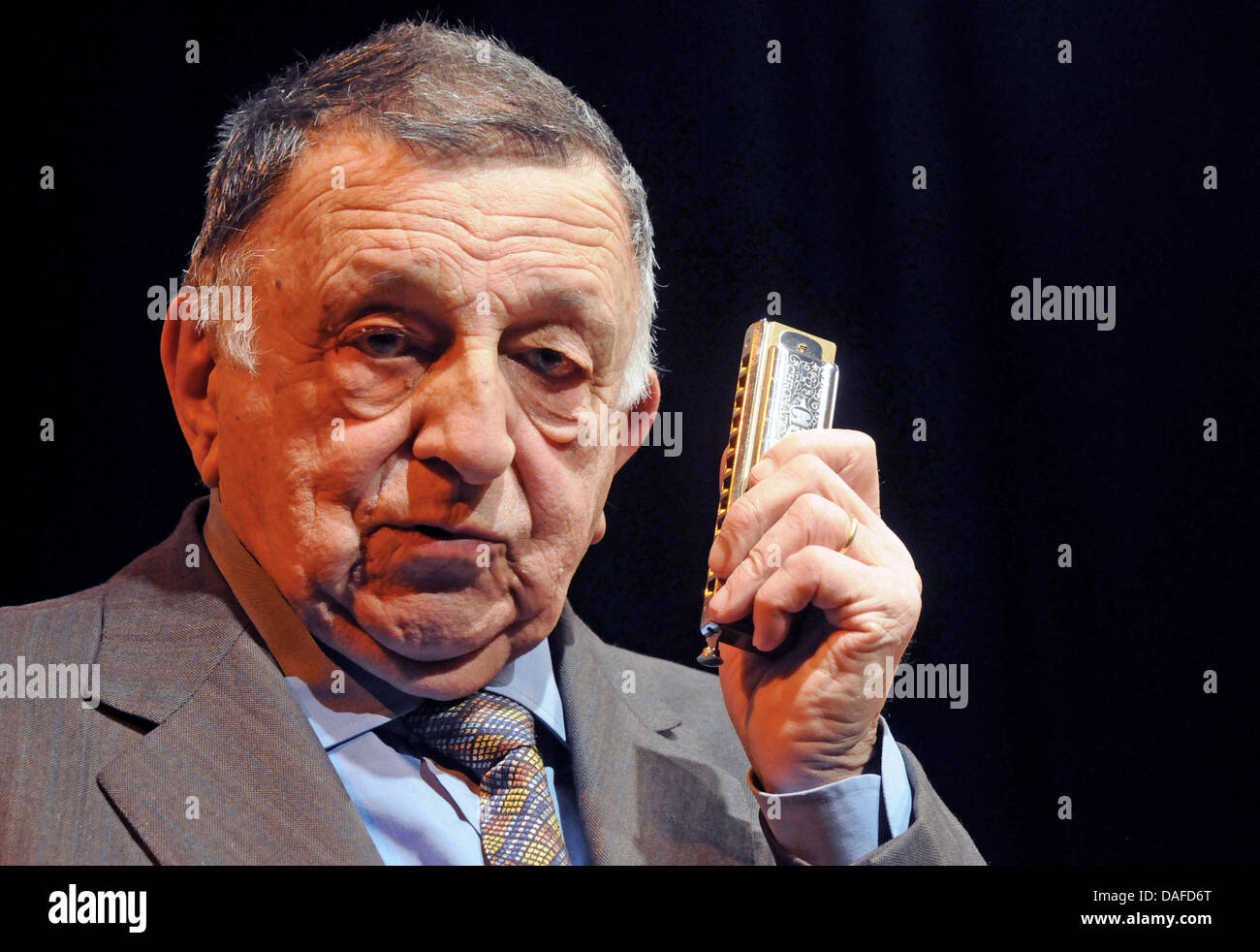 Italian harmonica legend Franco De Gemini plays his harmonica during a