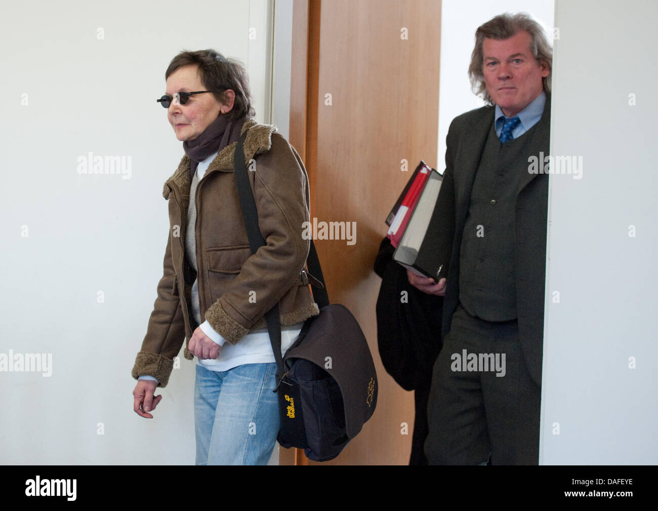 Former RAF terrorist and defendant Verena Becker arrives at the district court with her lawyer Hans Wolfgang Euler (R) in Stuttgart, Germany, 24 February 2011. Becker is accused of being an accomplice of the murder of Attourney General Buback in 1977. Photo: UWE ANSPACH Stock Photo