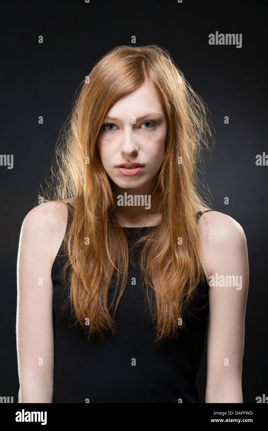 Portrait of young woman in black dress, close up Stock Photo