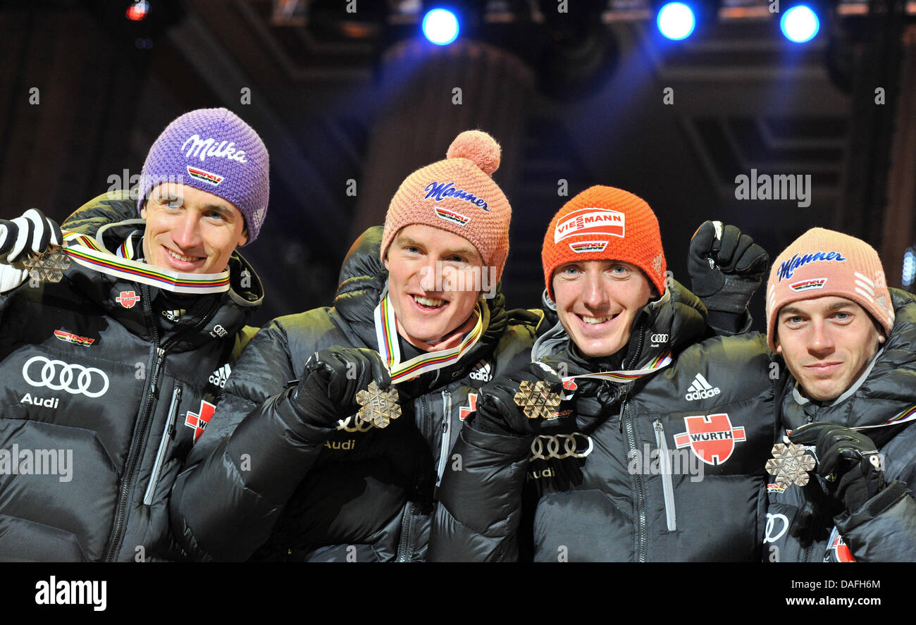 Bronze medalists Martin Schmitt (L-r), Severin Freund, Michael Uhrmann and Michael Neumayer of Germany show their medals during the medal ceremony after the Men's Ski Jumping Normal Hill team event at the Nordic Skiing World Championships at the Medal Plaza in Oslo, Norway, 27 February 2011. Photo: Hendrik Schmidt dpa Stock Photo
