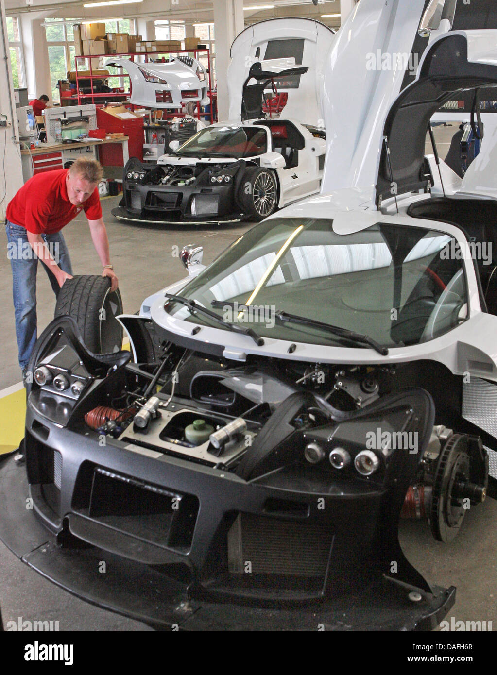 A file picture dated 4 June 2008 shows car mechanic Joerg Ottmann during work on the 650 horsepower fast car Apollo at the Gumpert sports car plant in Altenburg, Germany. The company will present their new car, the 700 horsepower Tornate, at the car showroom in Geneva, Switzerland. The name is a work-in-progress titel and is derived from the Italian word for switchback. The two-sea Stock Photo