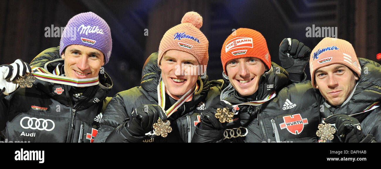 Bronze medalists Martin Schmitt (L-R), Severin Freund, Michael Uhrmann and Michael Neumayer of Germany show their medals during the medal ceremony after the Men's Ski Jumping Normal Hill team event at the FIS Nordic Skiing World Championships in Oslo, Norway, 27 February 2011. Photo: Hendrik Schmidt Stock Photo