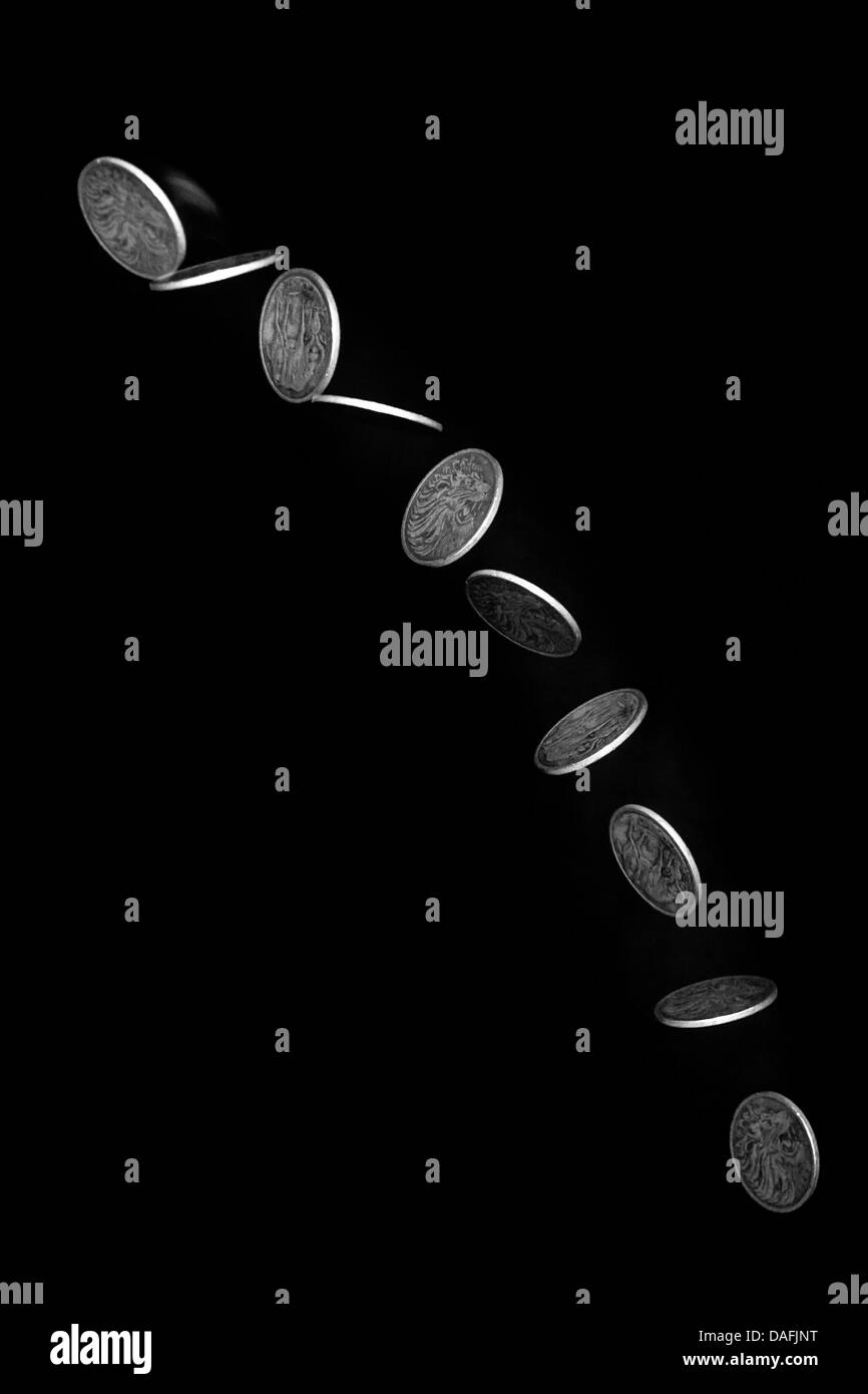 Stroboscopic effect created using flash capturing the motion of a coin