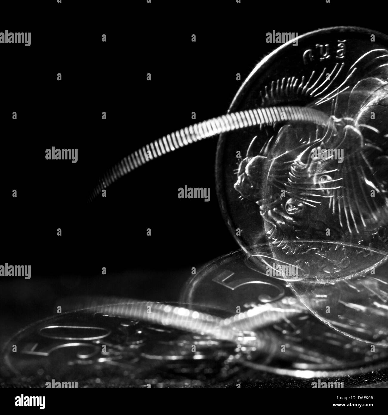 Stroboscopic effect created using flash capturing the motion of a coin as it is spinning Stock Photo