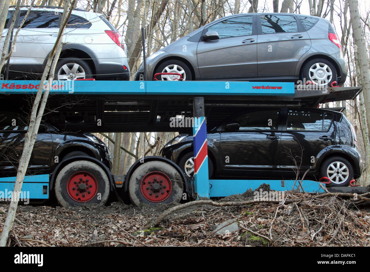 A car transporter parks in a wood near Greimersburg, Germany, 02 March 2011. The car transporter's driver relied on his satnav that obviously sent him the wrong way. Photo: THOMAS FREY Stock Photo