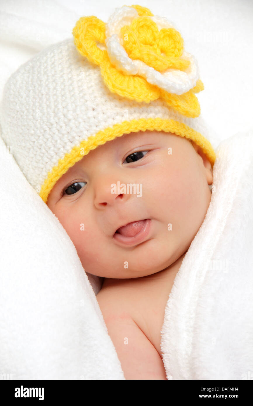 Baby with a knitted white hat with a flower Stock Photo
