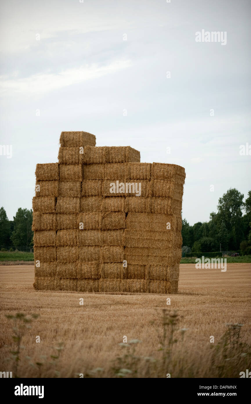 Tall stack bales of hey Guines France Stock Photo