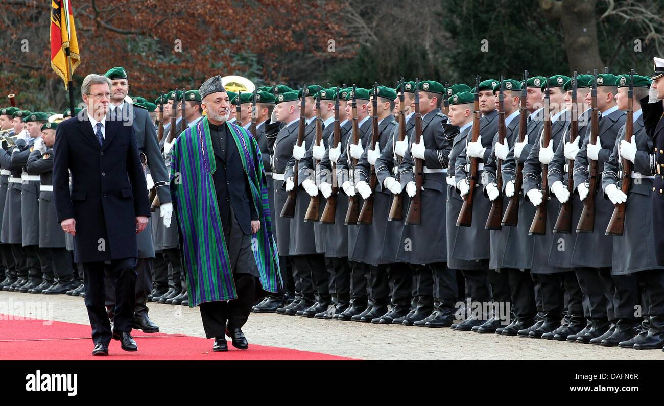 Afghanistan President Hamid Karsai is welcomed by German President Christian Wulff (L) with military honours at Bellevue Palace in Berlin, Germany, 06 December 2011. Karsai is on a one-day visit to the German capital. Photo: WOLFGANG KUMM Stock Photo