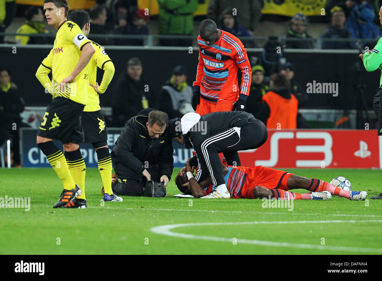 Marseille's Stephane Mbia is treated during the Champions League soccer match between Borussia Dortmund and Olympique Marseille at the Signal Iduna Park in Dortmund, Germany, 06 December 2011. Photo: Revierfoto Stock Photo