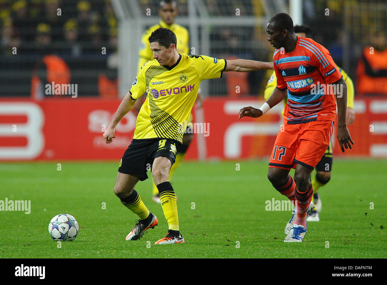 Dortmund's Robert Lewandowski (L) and Marseille's Stephane Mbia fight for the ball during the Champions League soccer match between Borussia Dortmund and Olympique Marseille at the Signal Iduna Park in Dortmund, Germany, 06 December 2011. Photo: Revierfoto Stock Photo