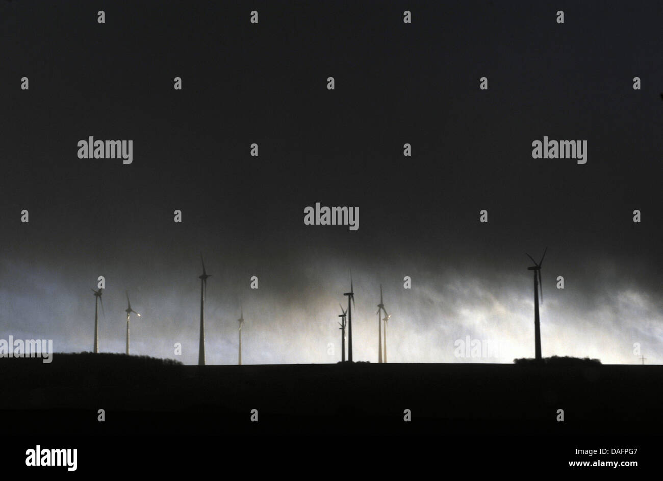 Wind turbines are swallowed by storm clouds near Istha, Germany, 07