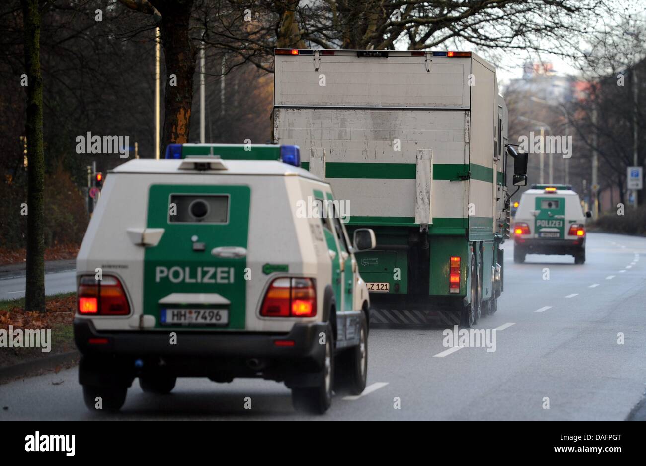 A money transporter is accompanied by police vans in Kiel, Germany, 08  December 2011. The transporters' routes and contents are top secret. Photo:  Carsten Rehder Stock Photo - Alamy