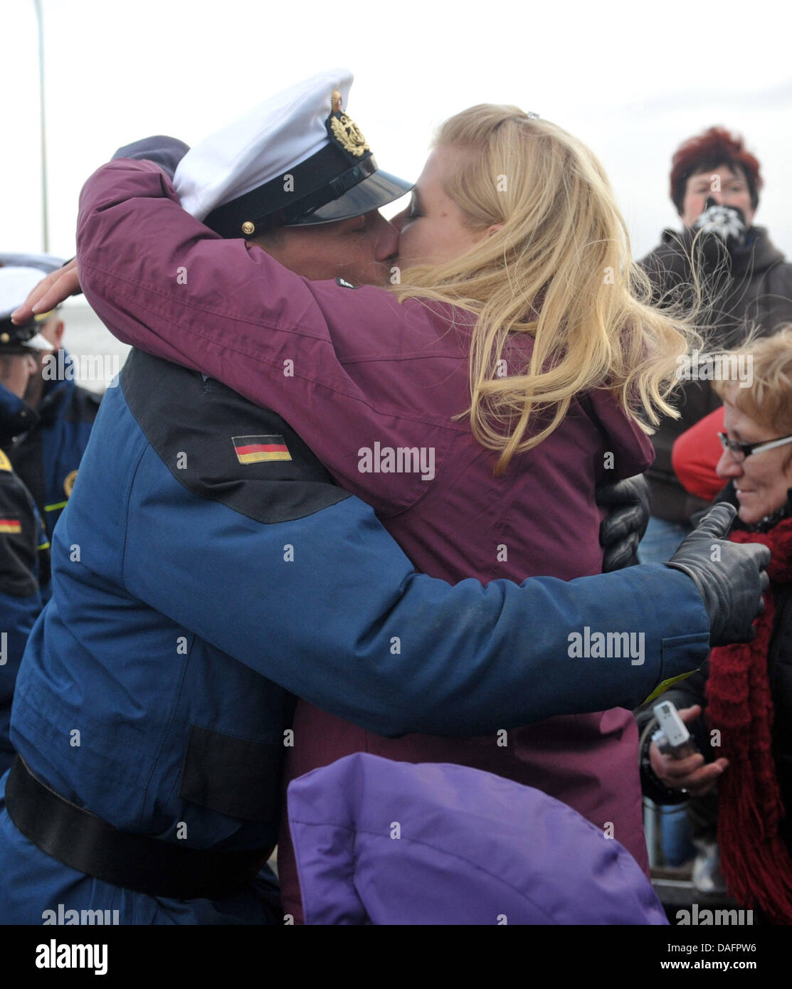 Petty Officer Second Class Gordon Bonitz greets his girlfriend Caroline  Nagel after the frigate "Koeln" arrives at the naval base in Wilhelmshaven,  Germany, 09 December 2011. In August, the German Navy ship