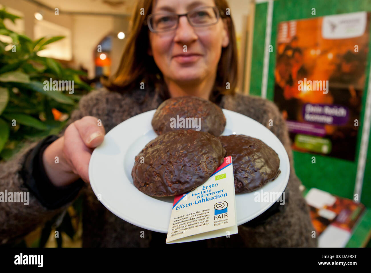 The owner of the world shop 'Fenster zur Welt' ('Window to the world'), Inge Rehm, presents traditional Elisen gingerbread of fair trade in Nuremberg, Germany, 09 December 2011. For the first time Nuremberg offers its traditional Elisen gingerbread as a 'fair trade' product to support farmers in the Philippines. Photo: Daniel Karmann Stock Photo