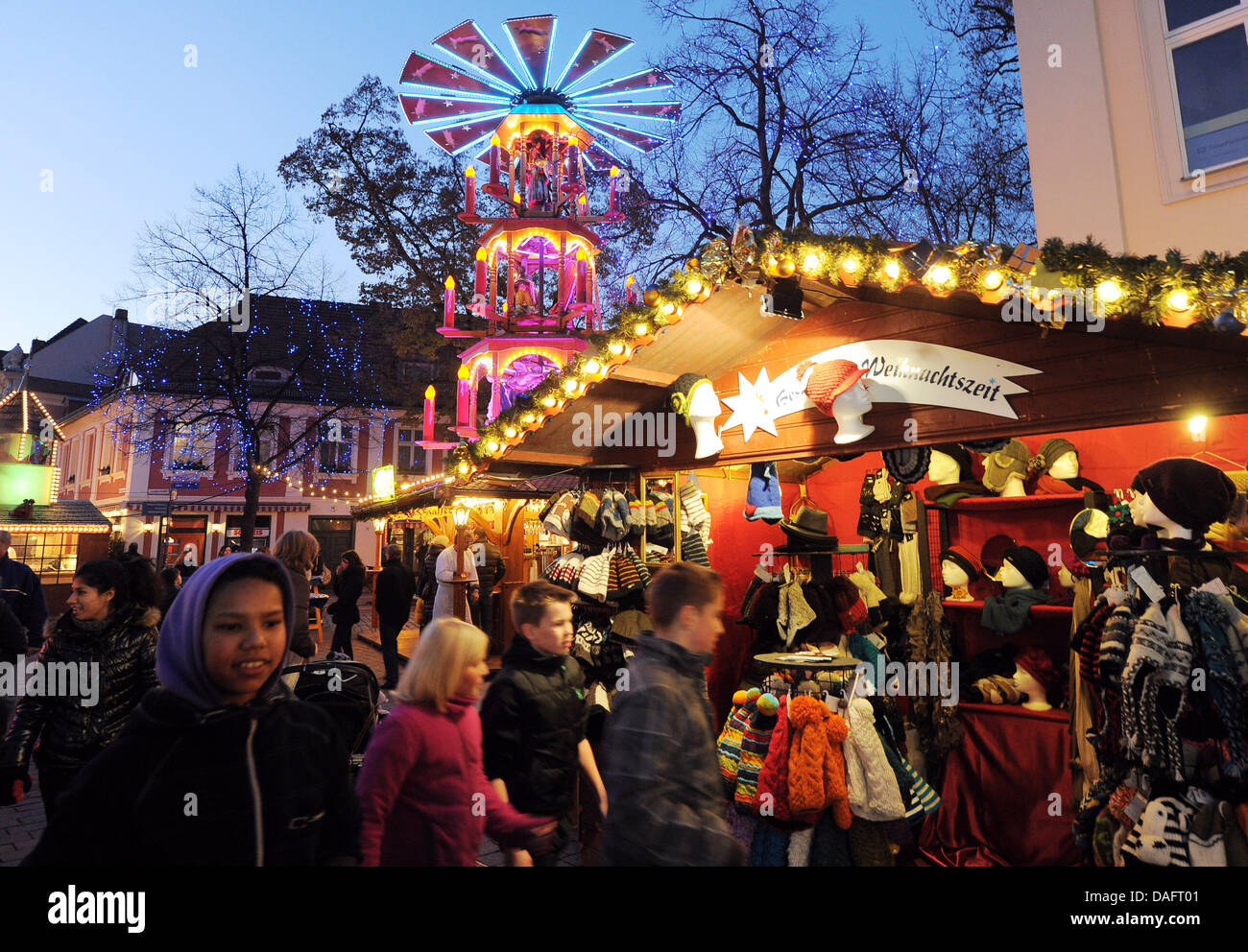 People walk by the Christmas market during its opening in Potsdam, Germany, 21 November 2011. Until 27 December 2011, around 800,000 people are expected to visit the market.Photo: Bernd Settnik Stock Photo