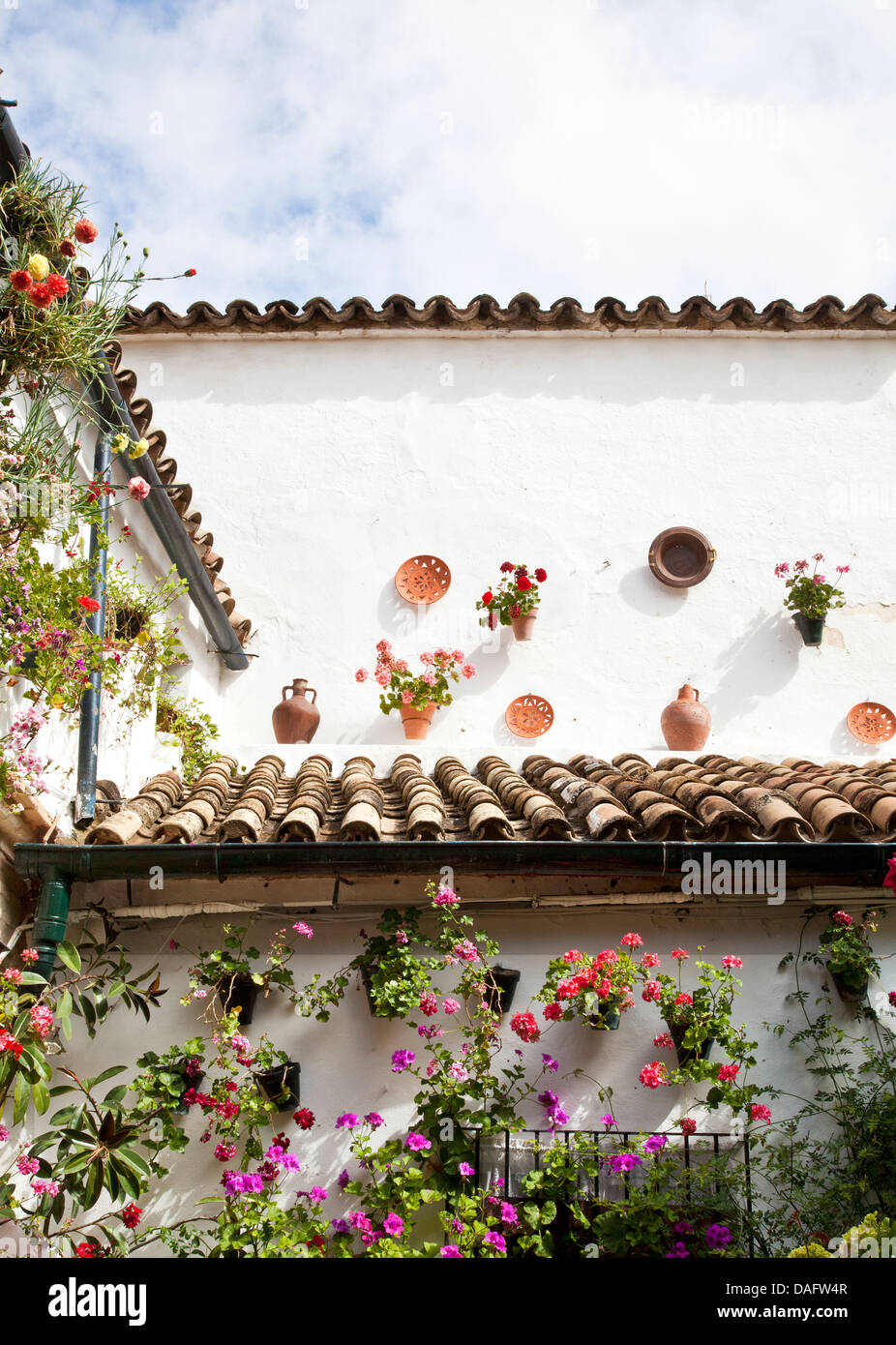 HOUSE DECORATED WITH FLOWERPOTS. Stock Photo