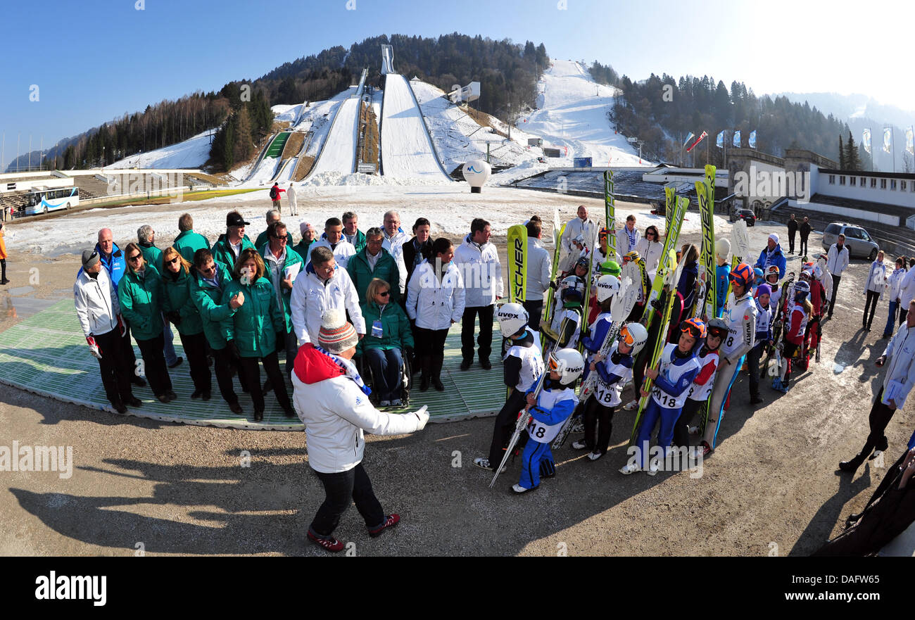 The members of the evaluation committee of the International Olympic Committee IOC stand together with the members of the Munich candidature company and a group of Ski Club Garmisch Partenkirchen members in the finish line area of the olympic hill in Garmisch-Partenkirchen, Germany, 2 March 2011. The evaluation committee visits Munich and it's relevant area to evaluate on the Munic Stock Photo