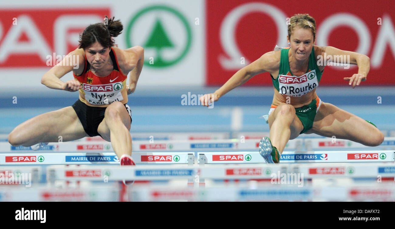 German athlete Carolin Nytra (L) is pictured in action next to Irish athlete Derval O'Rourke during the 60m hurdle race of the European Athletics Indoor Championships at the Palais Omnisports in Paris, Germany, 04 March 2011. Photo: Arne Dedert Stock Photo