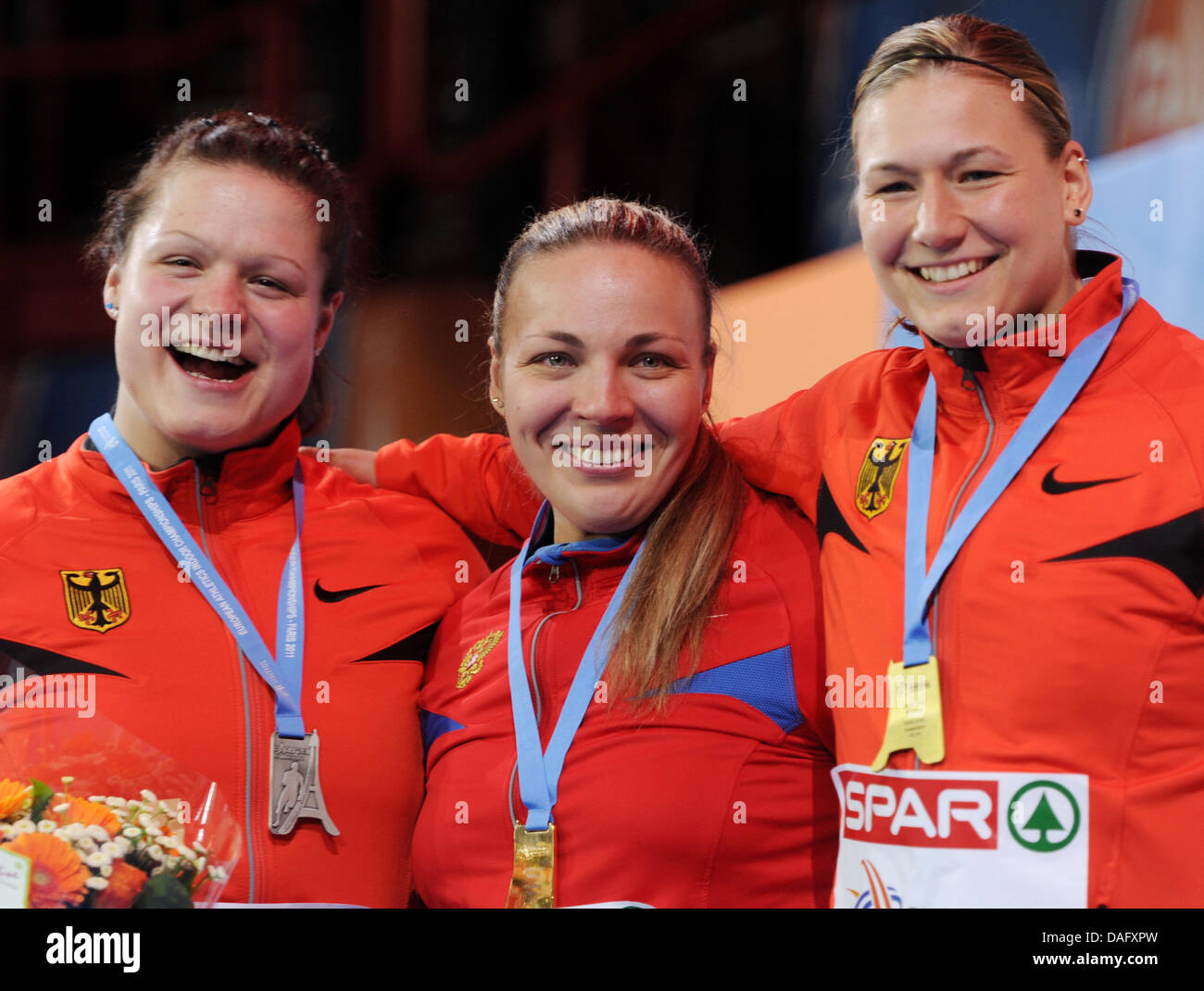 (L to R:) Germany's Christina Schwanitz (silver), Russia's Anna Avdeyeva (gold) and Germany's Josephine Terlecki (bronze) pose for a picture with their medals after the women's hot put competition of the NAIA Indoor Track & Field Championship at Palais Omnisports in Paris, France, 05 March 2011. Photo: Arne Dedert Stock Photo