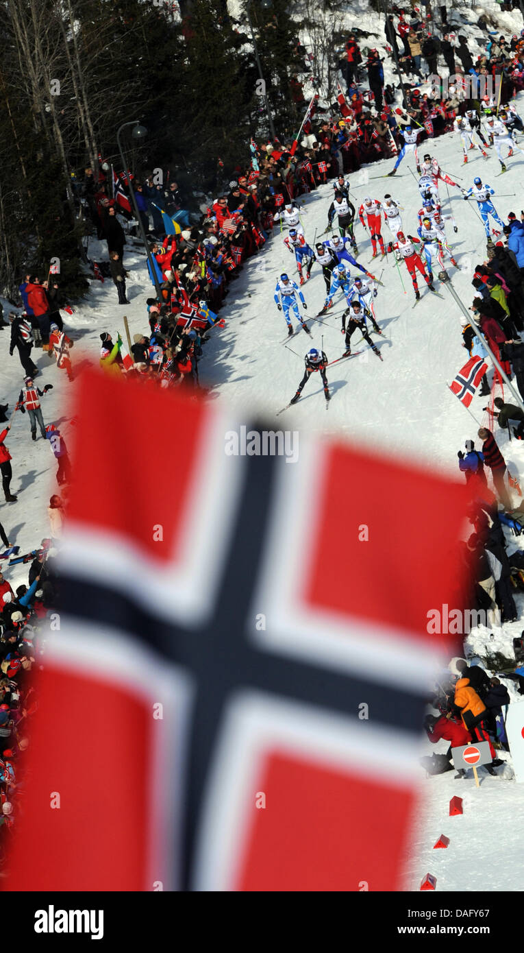 Competitors are pictured in action during the Cross Country Skiing Men