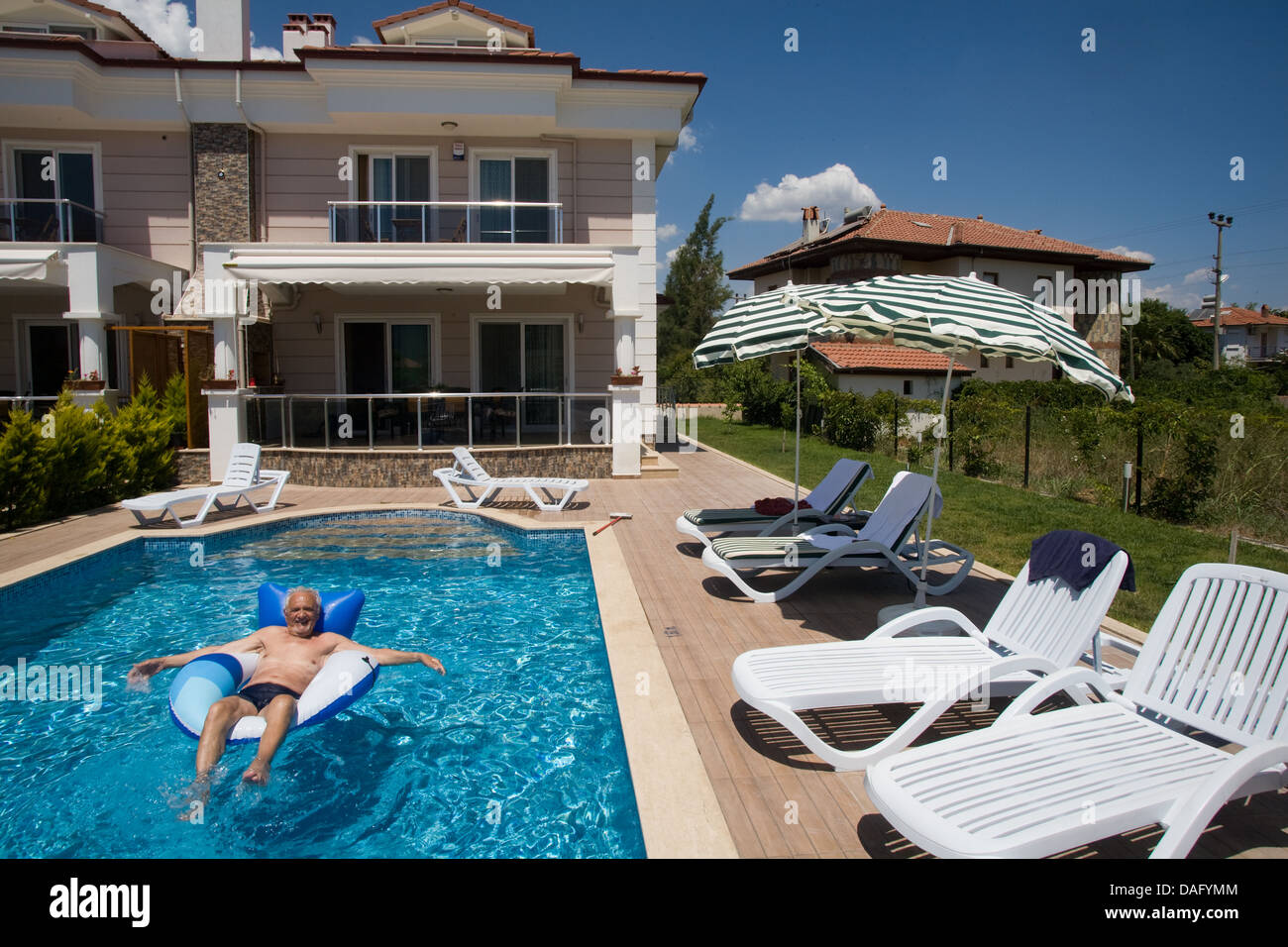 Holiday maker enjoys pool in holiday villa Dalyan Turkey Stock Photo