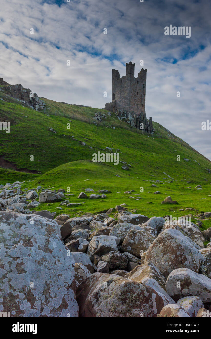 Dunstanburgh castle sits high on the headland. Stock Photo